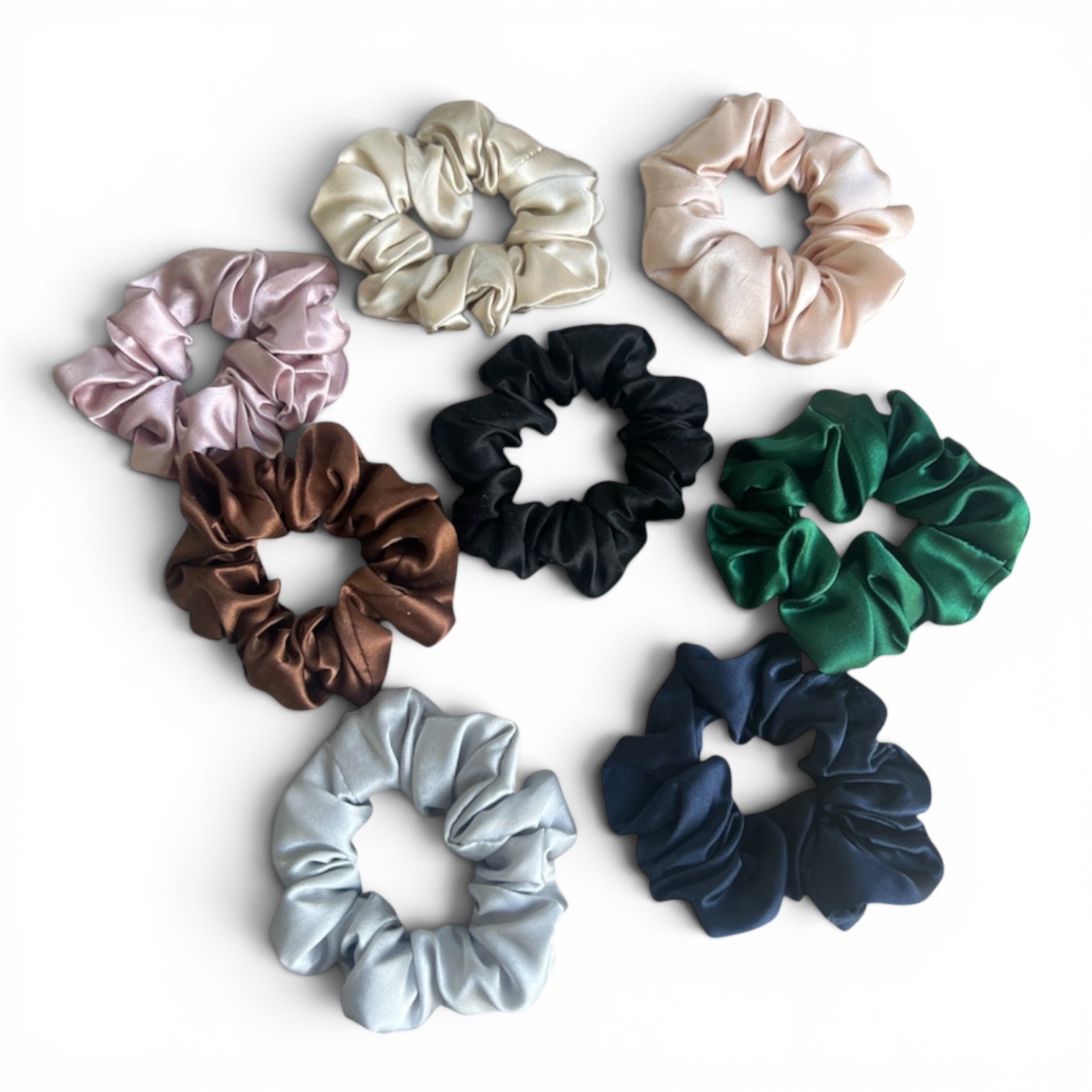 Set of colorful silk scrunchies on a white background
