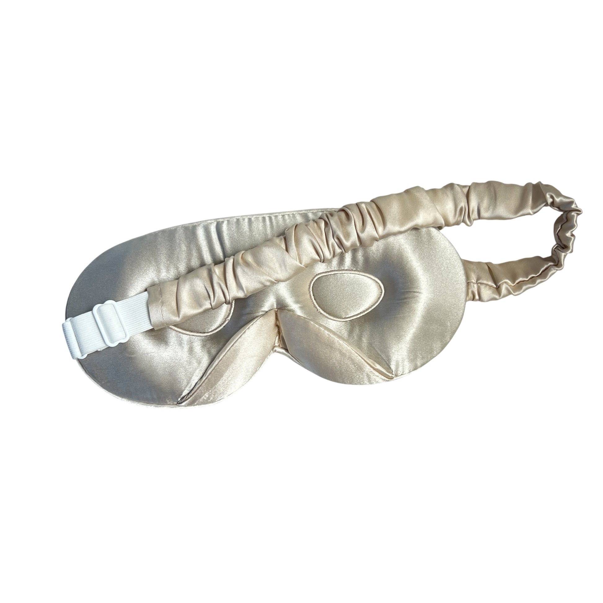 Gold silk eye mask on a white background