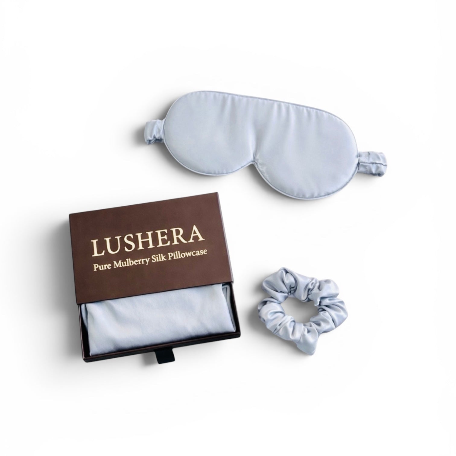 Silk pillowcase, eye mask, and scrunchie set with Lushera branding on a white background