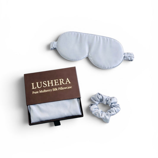 Silk pillowcase, eye mask, and scrunchie set with Lushera branding on a white background