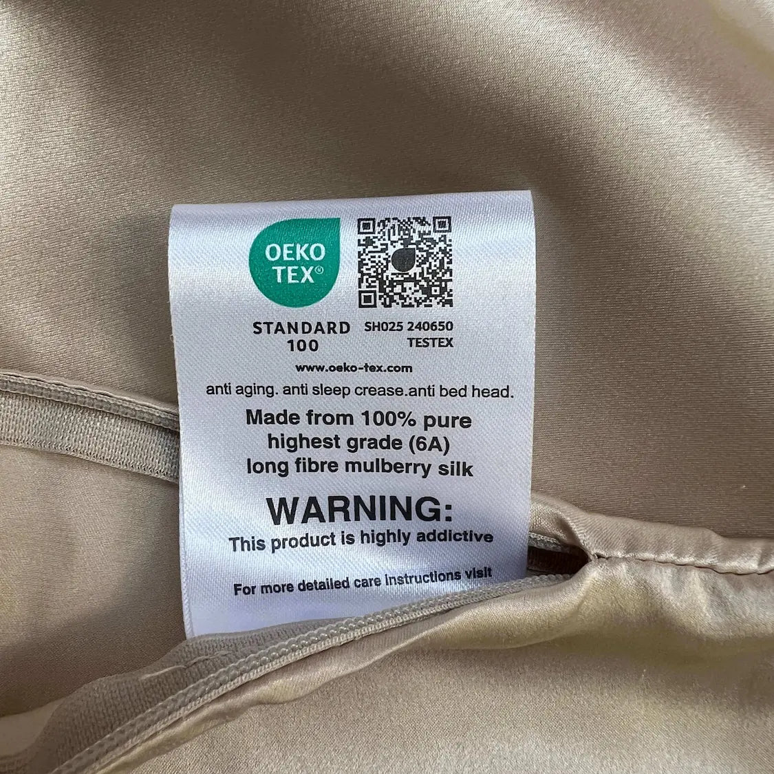 OEKO-TEX label on a beige fabric background