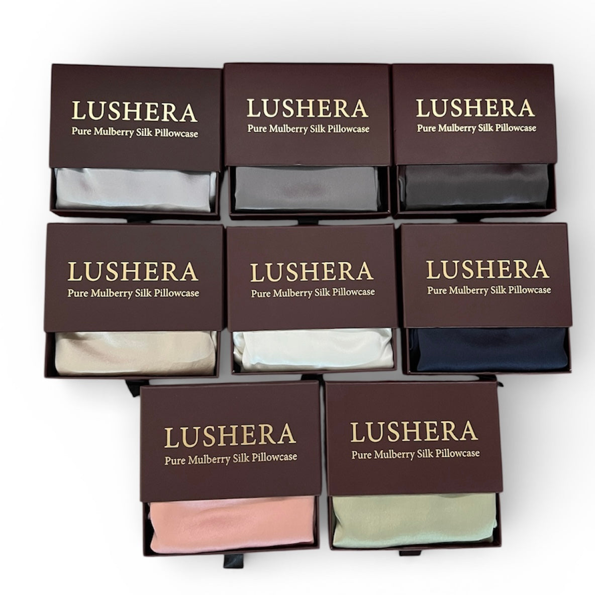 Multiple Lushera pure mulberry silk pillowcases in various colors displayed in boxes on a white background.